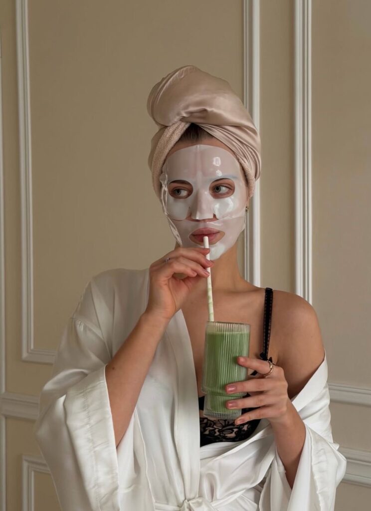 Skin care lady  protecting her inner health by drinking healthy green juice