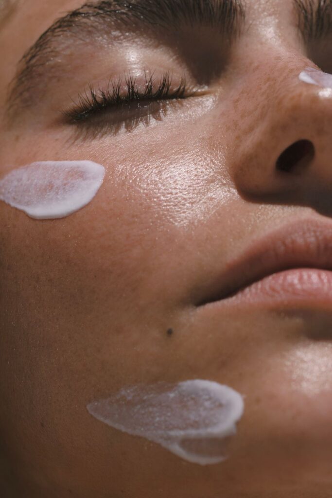 A lady who applied sunscreen and is looking at the sun