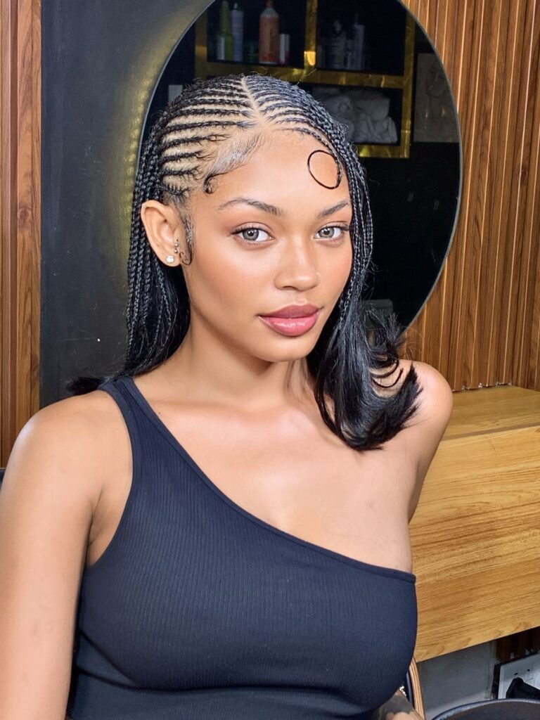 Lady putting on trendy Tyla hairstyle