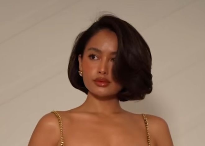 Lady putting on trendy 90s bob hairstyle 