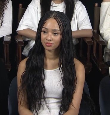Classy lady putting on trendy boho braids hairstyle 