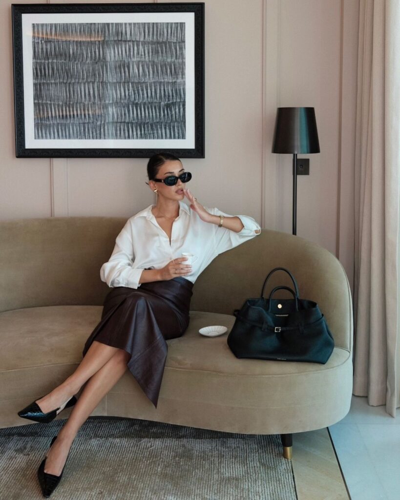 Chic classy lady putting on spring outfit 