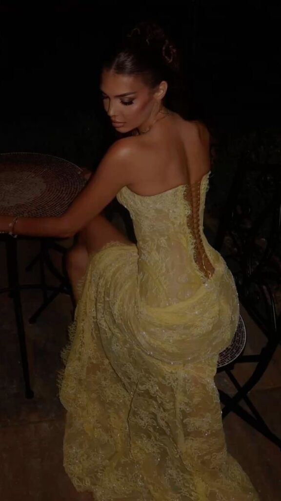 Lady putting on a classy yellow prom dress