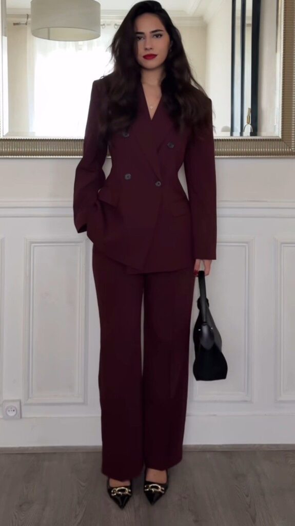Lady putting on a burgundy suit