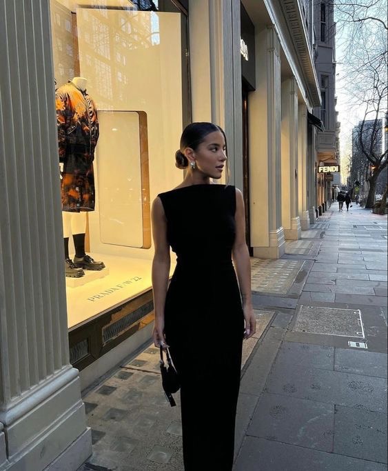 Classy lady putting on a black dress