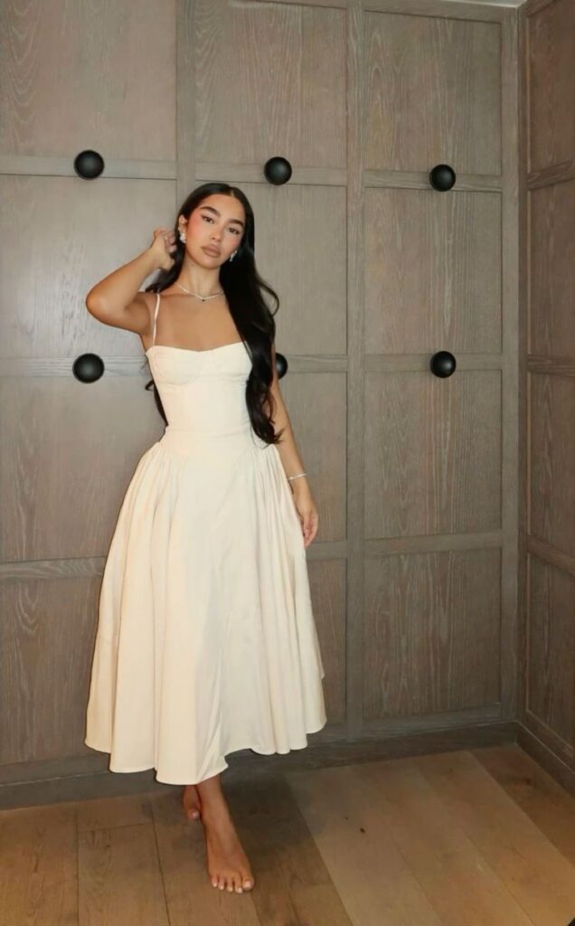 Lady putting on a classy sundress 