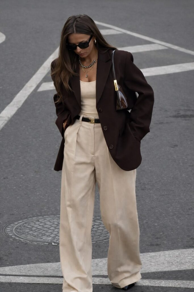 Classy lady putting on a brown blazer