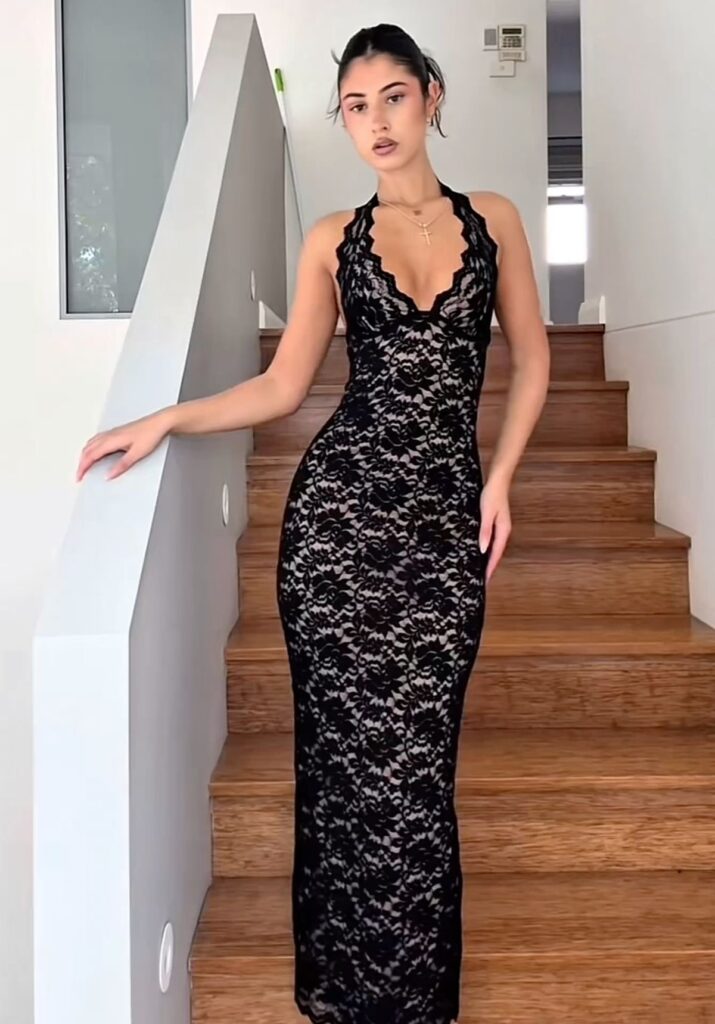 Lady putting on a black lace dress for date night 