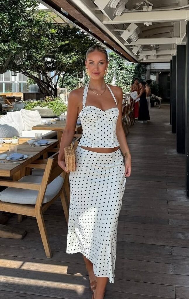 Classy lady putting on a polka dot 2 piece 