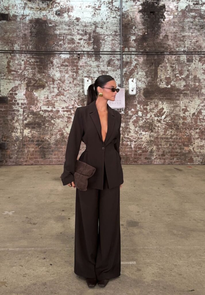 Classy lady putting on a monochrome chic brown suit 